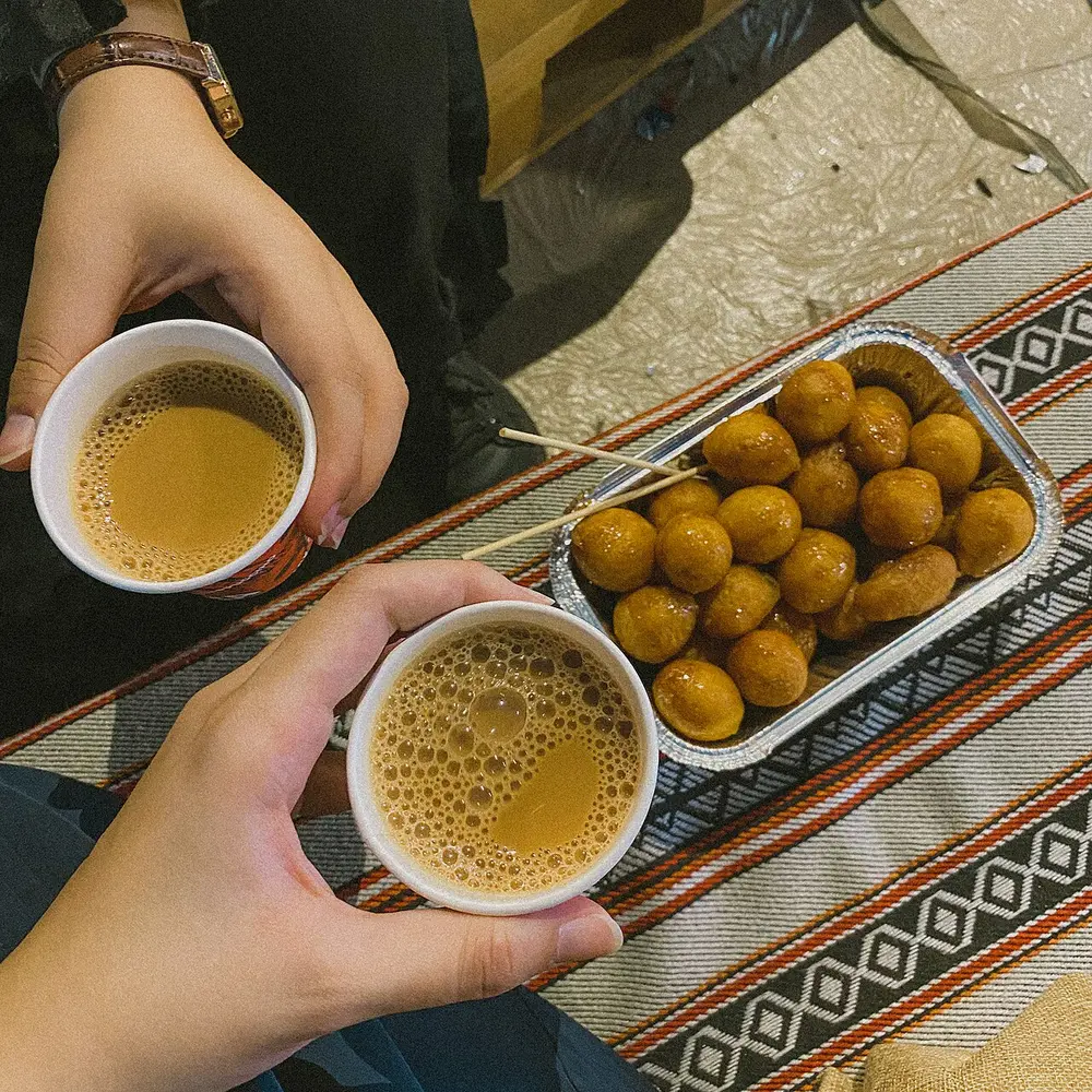 Karak chai with luqaimat, sweet dumplings drizzled with date syrup
