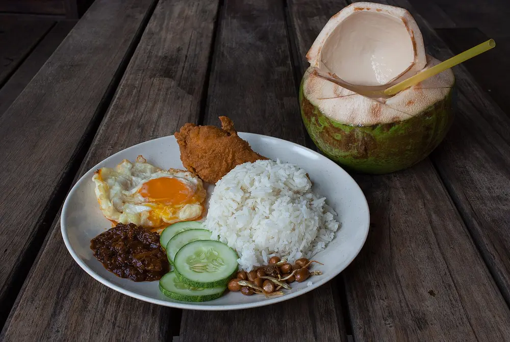 Nasi lemak with sambal, fried chicken, egg and peanuts